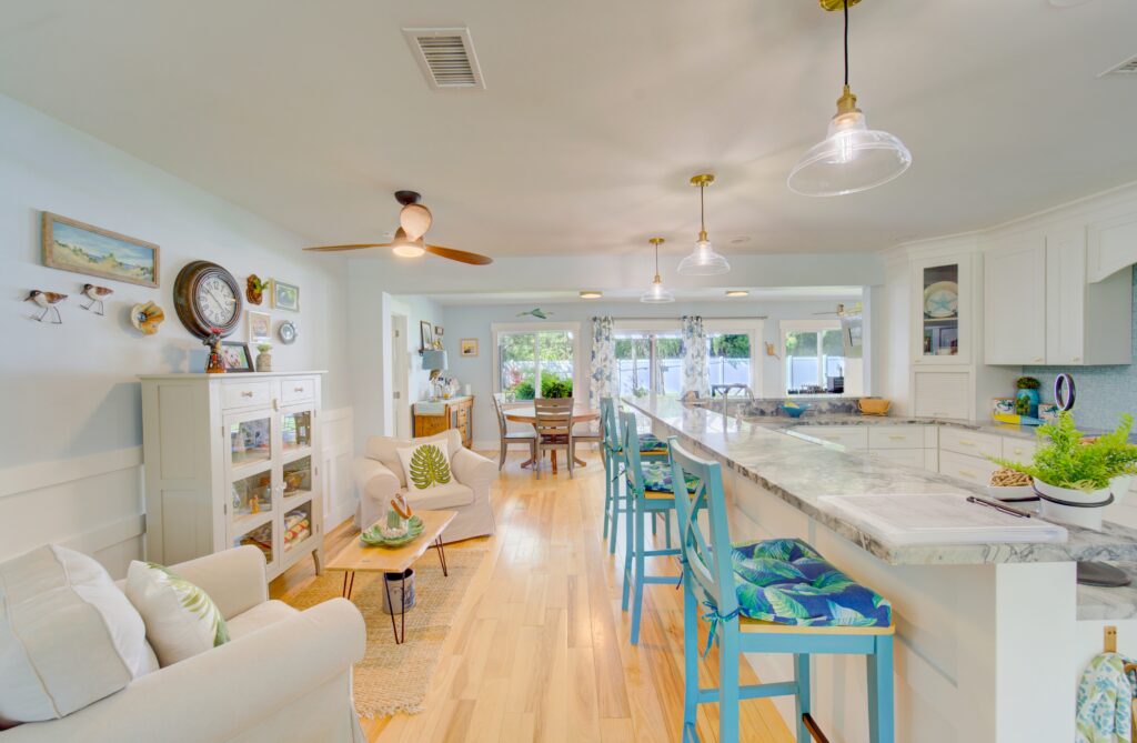 Professional vacuum cleaner on light hardwood floor during residential cleaning