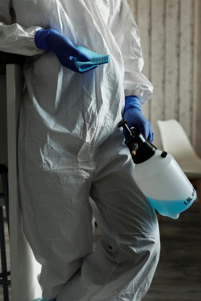 Professional cleaning worker wiping and sanitizing surfaces