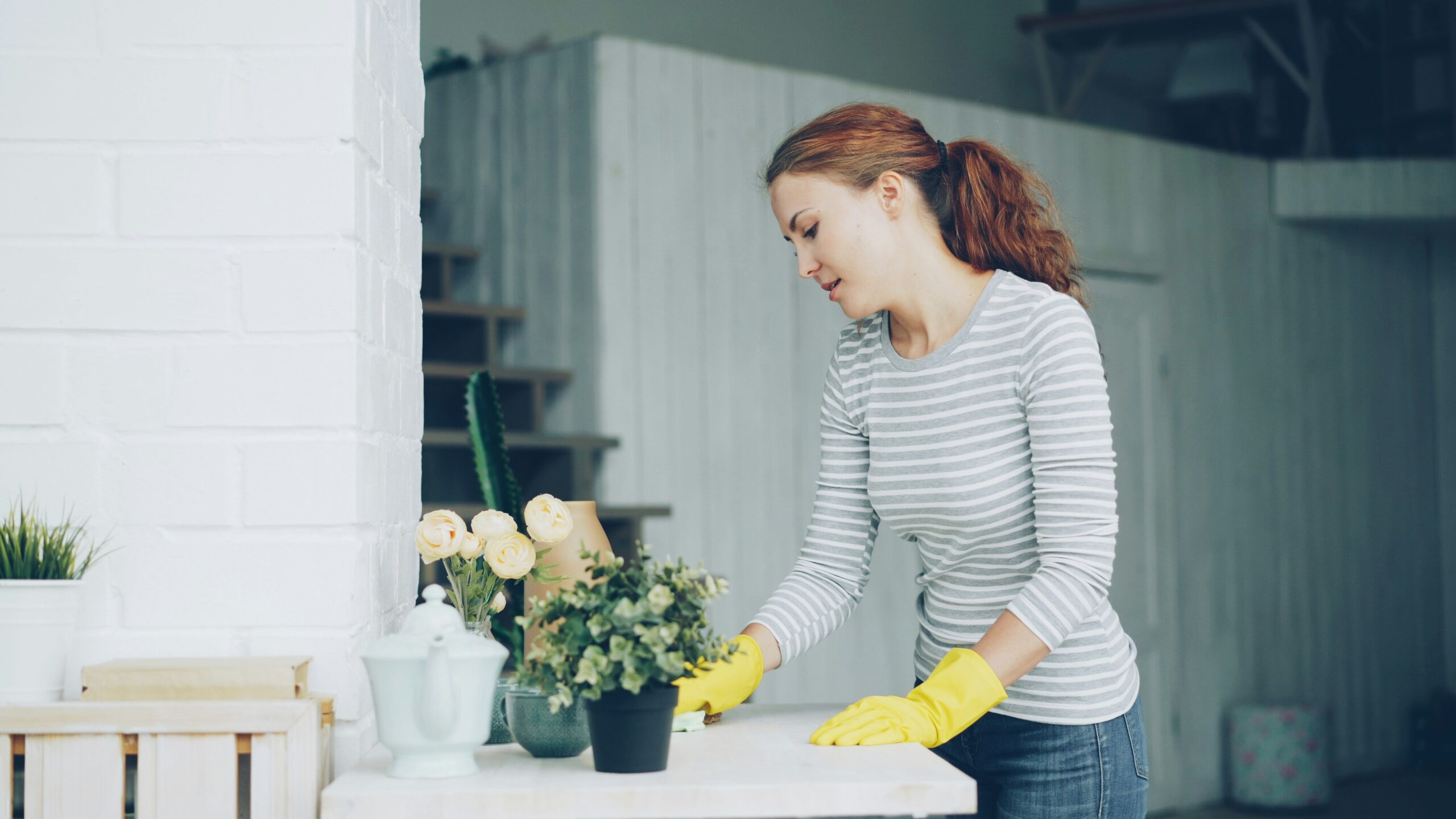 Cleaner wiping a dining table between vacation rental guests
